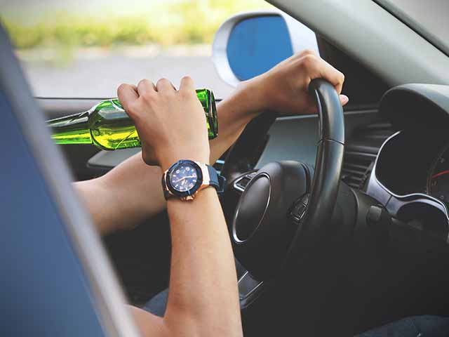 man drinking and driving